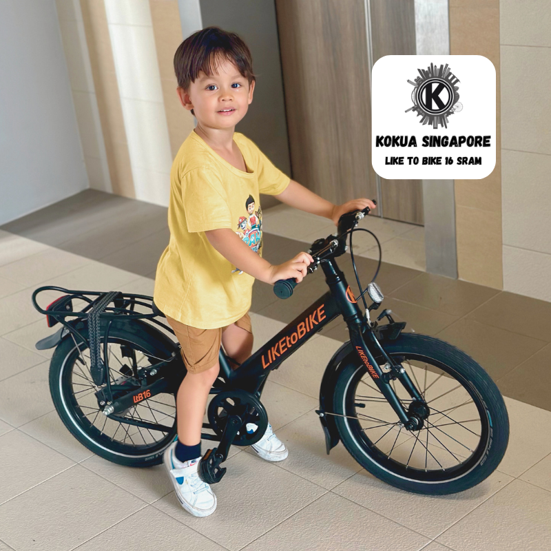 a little boy riding a bike in a building