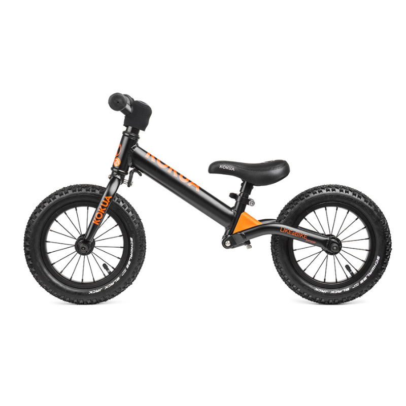 a black and orange KOKUA  Jumper 12 balance bike on a white background