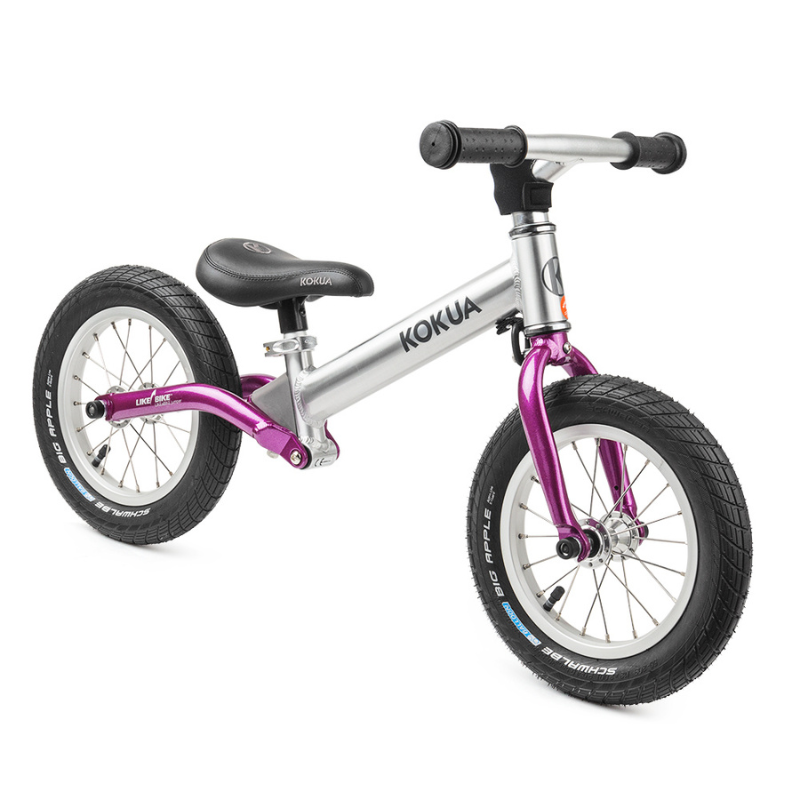 a silver and purple KOKUA Jumper 12 balance bike on a white background